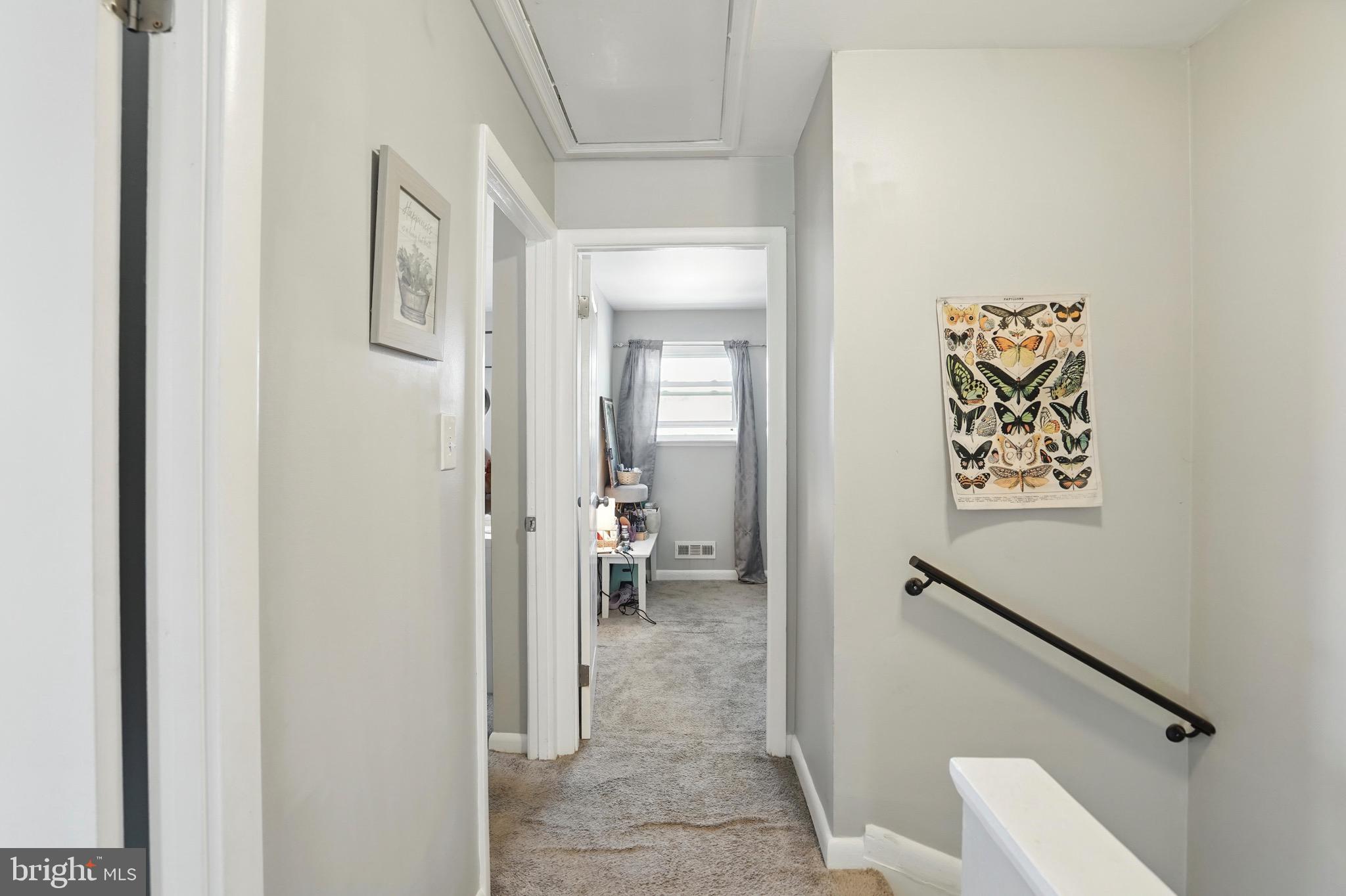 7812 Jamesford Road Dundalk, MD 21222 - Photo 23 of 30 a view of a hallway with wooden floor and a bathroom