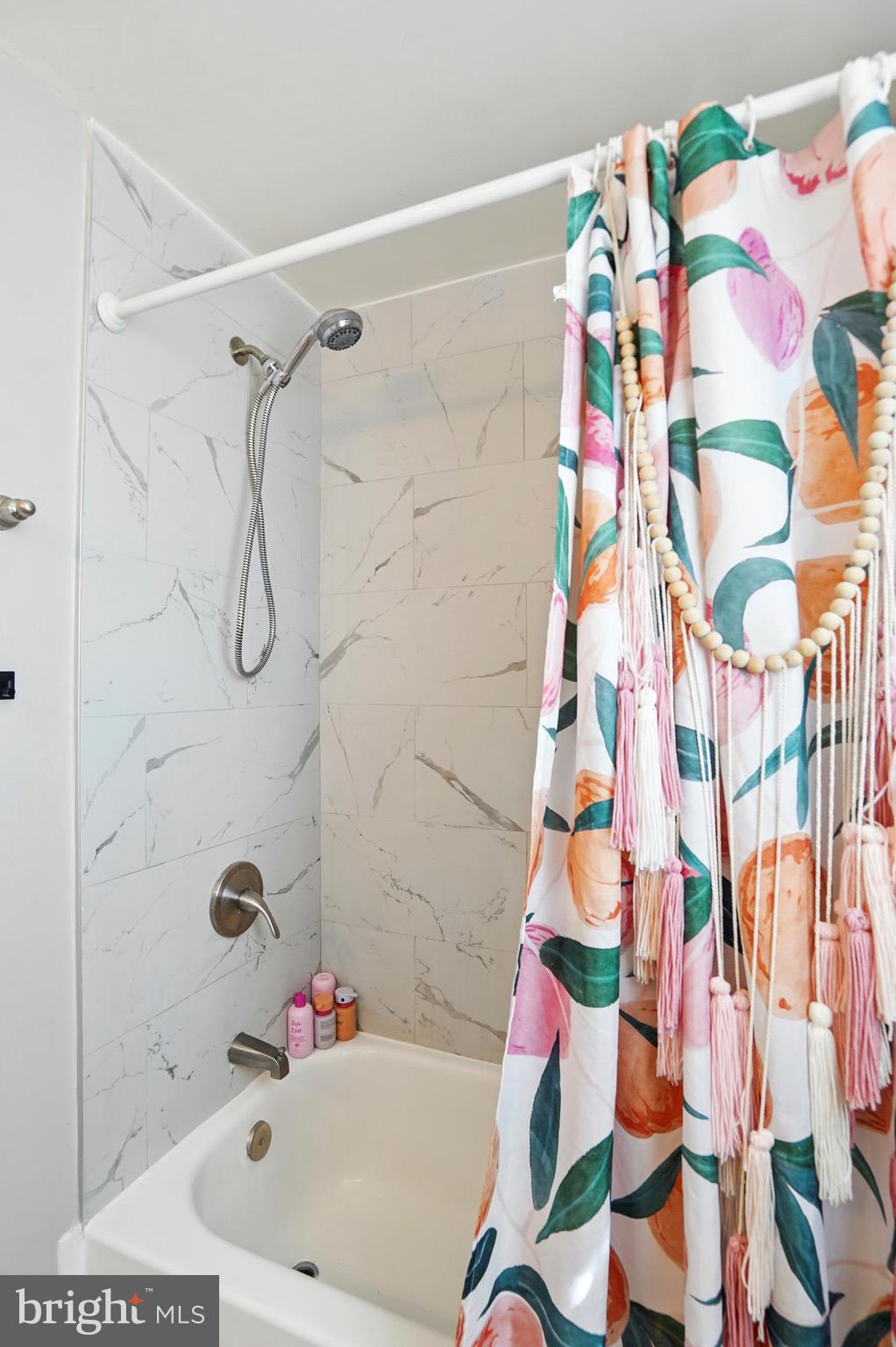 7812 Jamesford Road Dundalk, MD 21222 - Photo 29 of 30 a bathroom with a bathtub and shower curtain