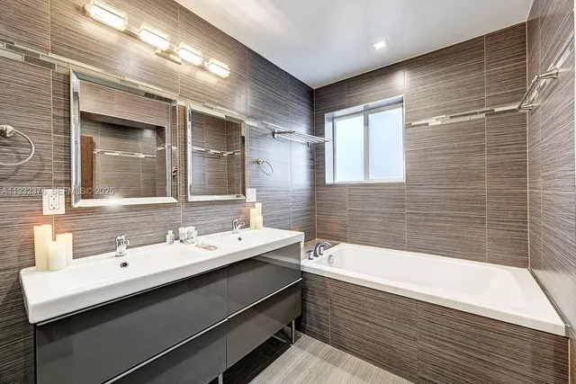 a bathroom with a bathtub and a sink