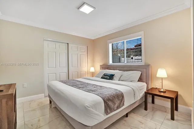 a bedroom with a bed and a night stand