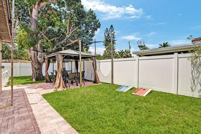 a view of a patio with a table and plants