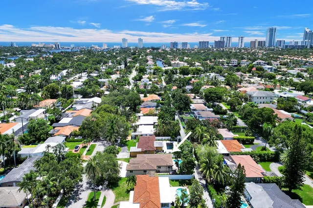 an aerial view of residential houses with city view