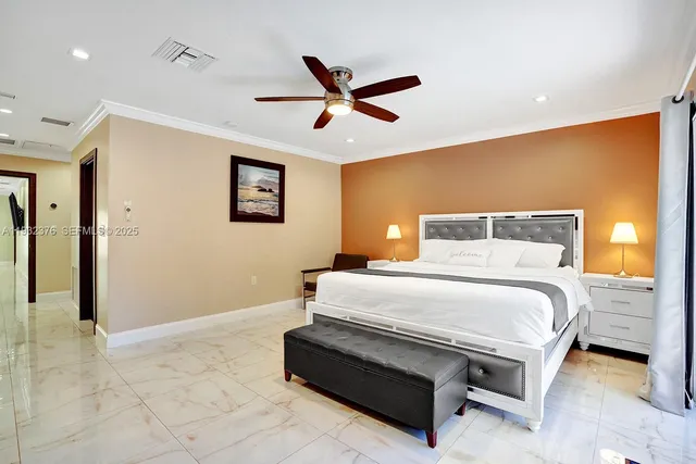 a bedroom with a bed and a ceiling fan