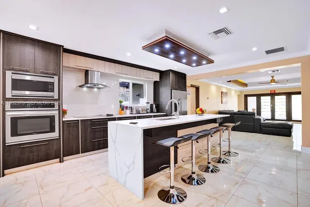 a kitchen with stainless steel appliances kitchen island granite countertop a sink and cabinets