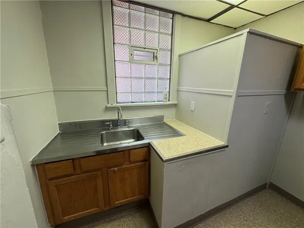 a kitchen with a refrigerator and a more cabinets