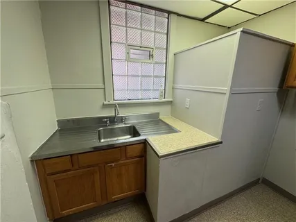 a kitchen with a sink and a refrigerator