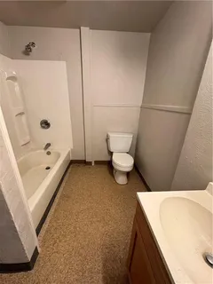 a bathroom with a sink a toilet and bathtub