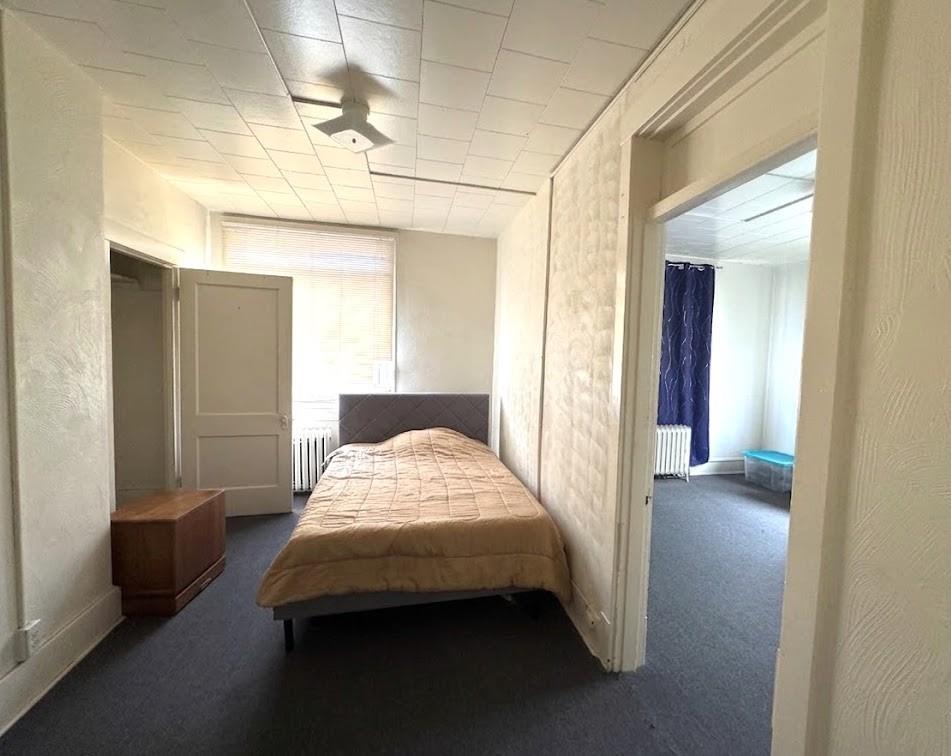 650 Ardmore Boulevard Pittsburgh, PA 15221 - Photo 42 of 48 a bedroom with a bed and a mirror