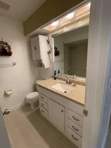 a bathroom with a sink a toilet and mirror