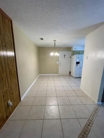 a view of an empty room and a bathroom