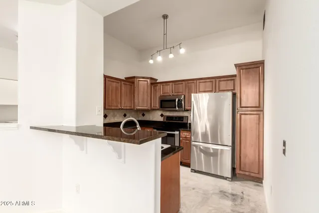 a kitchen with granite countertop a sink and cabinets