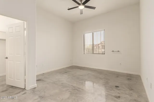 an empty room with an entrance to other room