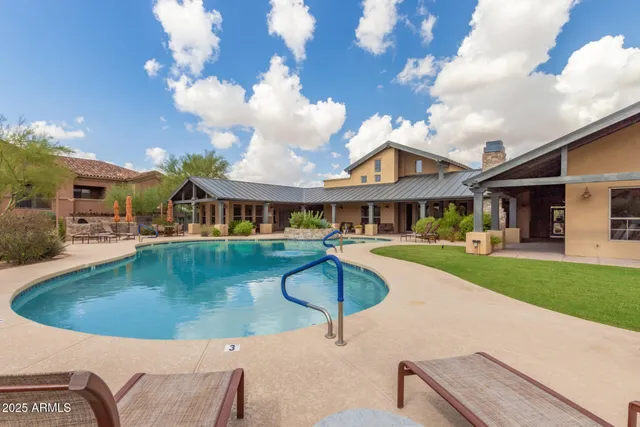 an outdoor sitting area with furniture and umbrella