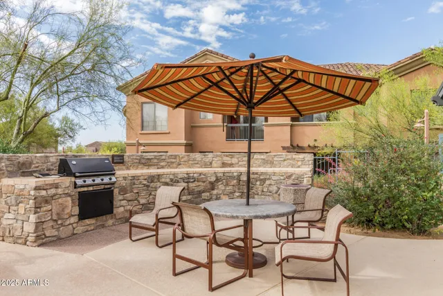 a view of a house with a swimming pool and sitting area