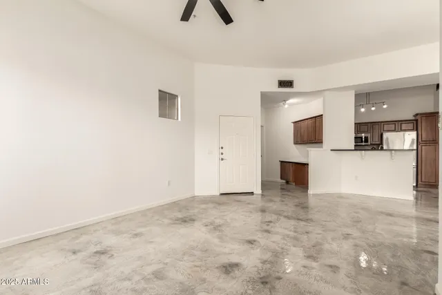 a view of kitchen with furniture and a ceiling fan