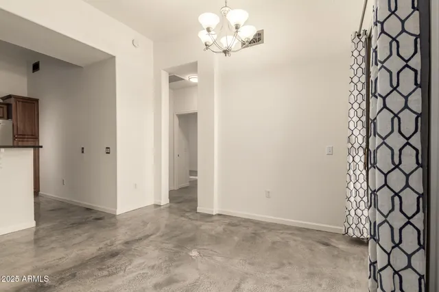 a view of a chandelier in big room with a chandelier
