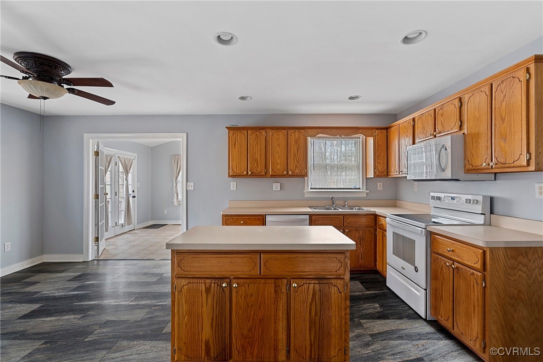 4350 Broadstreet Road Gum Spring, VA 23065 - Photo 18 of 48 a kitchen with a sink a stove cabinets and wooden floor