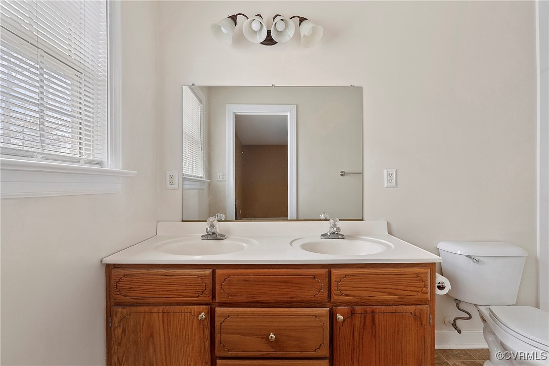 4350 Broadstreet Road Gum Spring, VA 23065 - Photo 38 of 48 a bathroom with a sink a toilet and mirror