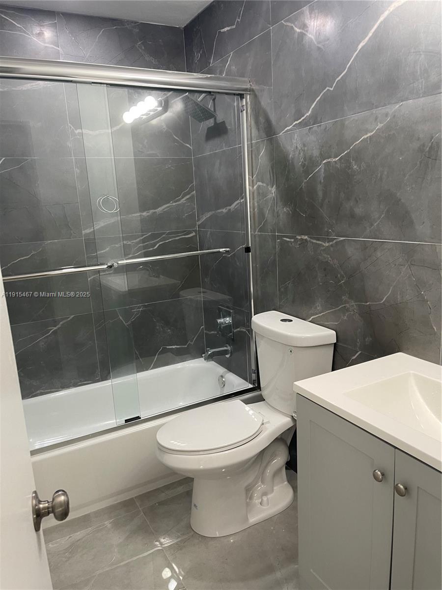 4281 Riverside Drive, Unit 1 Coral Springs, FL 33065 - Photo 4 of 7 a white toilet sitting next to a bathroom sink