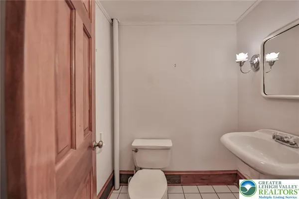 a bathroom with a toilet a sink and mirror