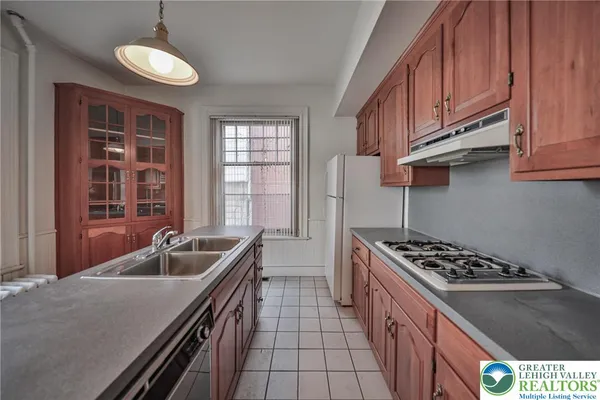 a kitchen with stainless steel appliances granite countertop a sink stove and cabinets