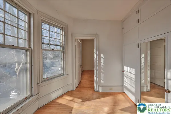 a view of an entryway with wooden floor and door