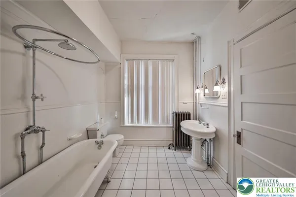 a view of an empty room with glass door and windows