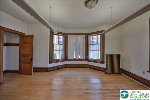 a view of a room with wooden floor and window