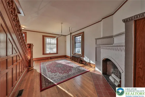 a view of an entryway with furniture fire place and wooden floor