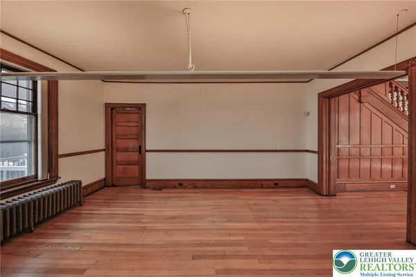 a view of a room with wooden floor