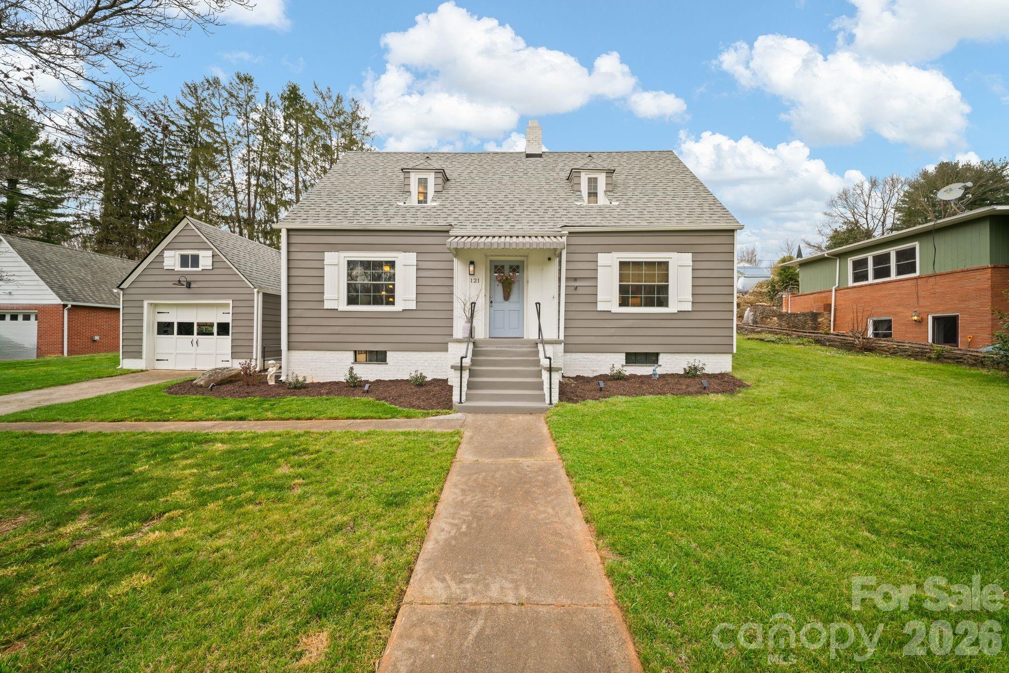 121 Johnson Street Canton, NC 28716 - Photo 1 of 32 a front view of house with yard and green space