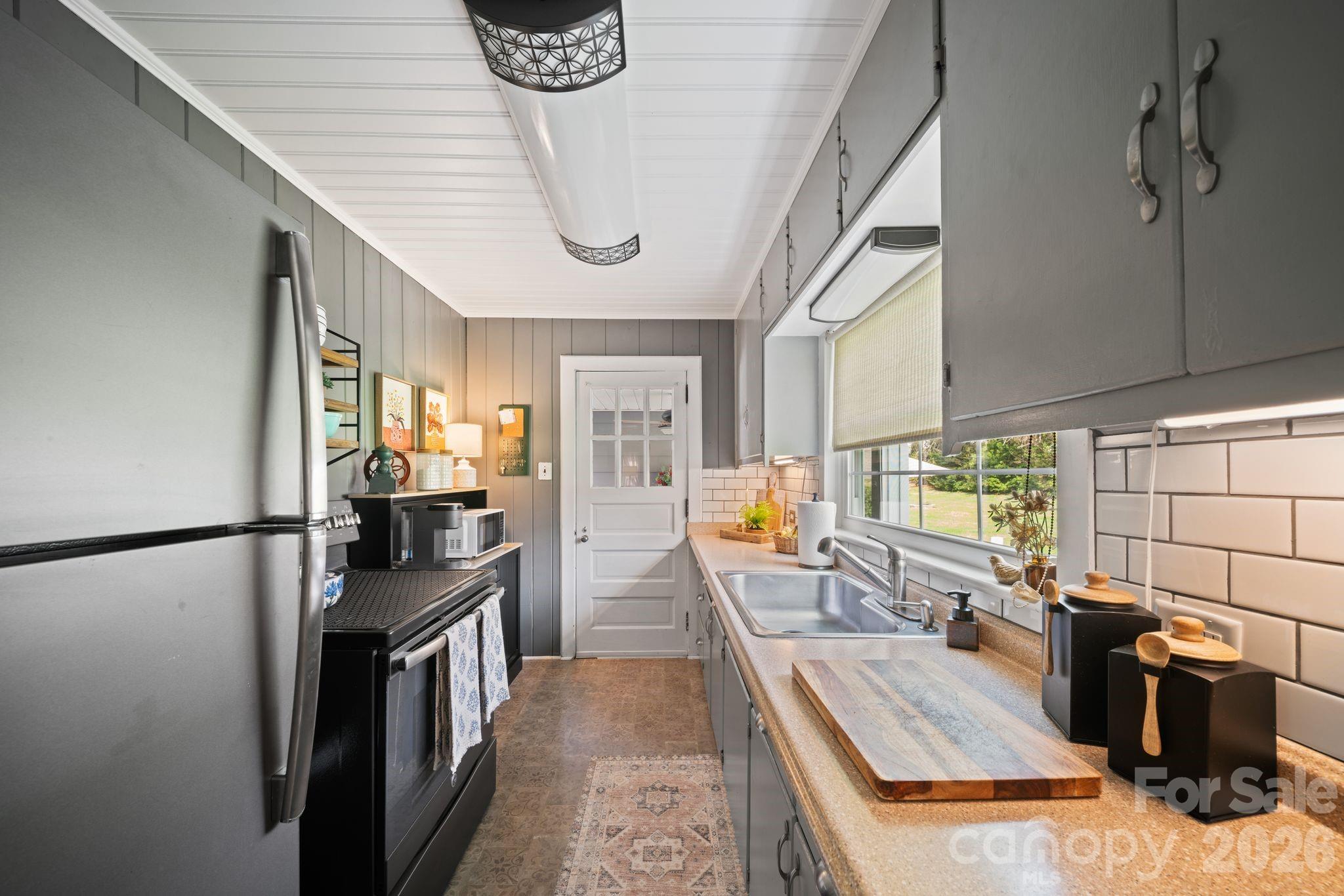 121 Johnson Street Canton, NC 28716 - Photo 16 of 32 a kitchen with stainless steel appliances granite countertop a refrigerator a stove and a sink with cabinets