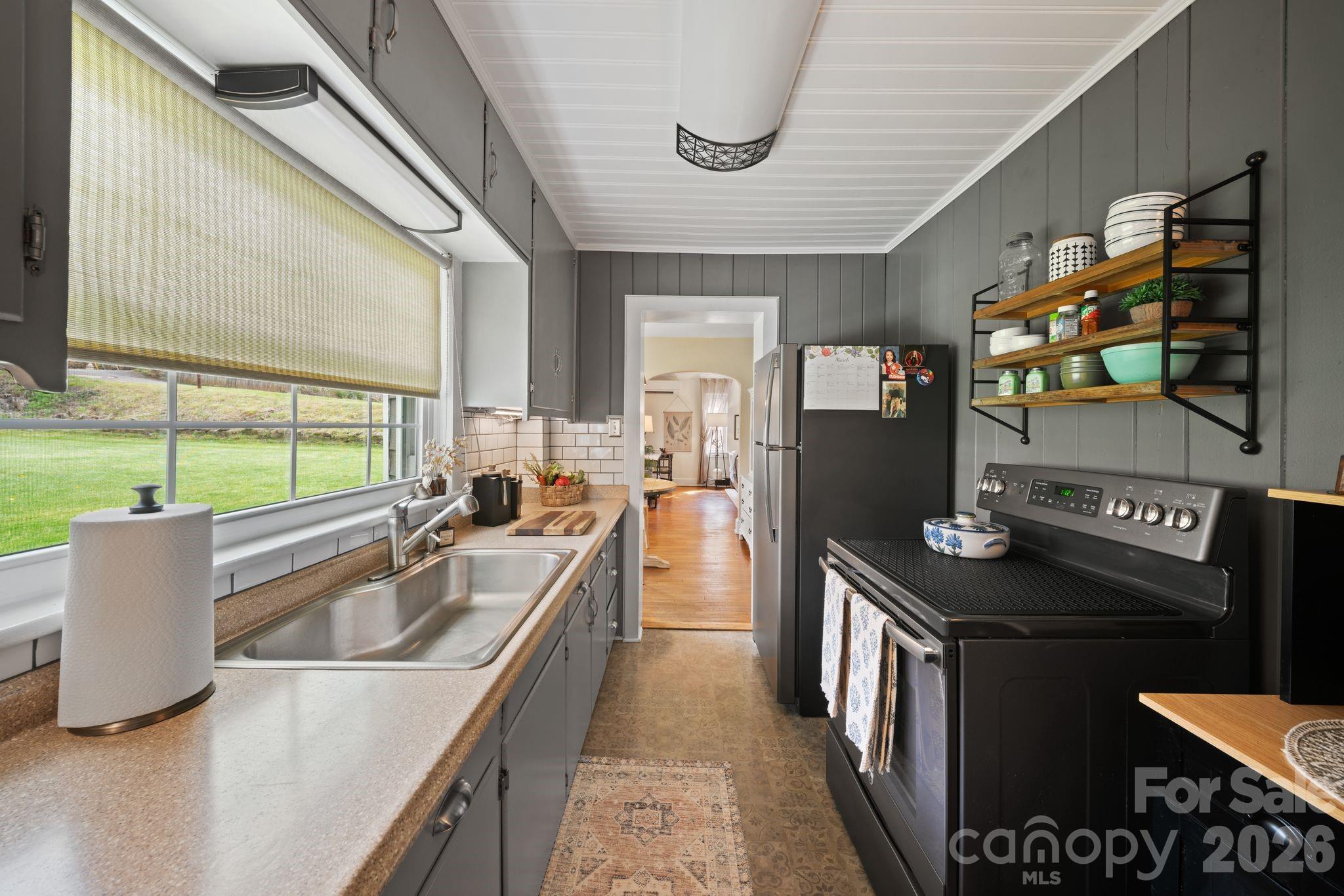121 Johnson Street Canton, NC 28716 - Photo 17 of 32 a kitchen with stainless steel appliances granite countertop a sink and a refrigerator