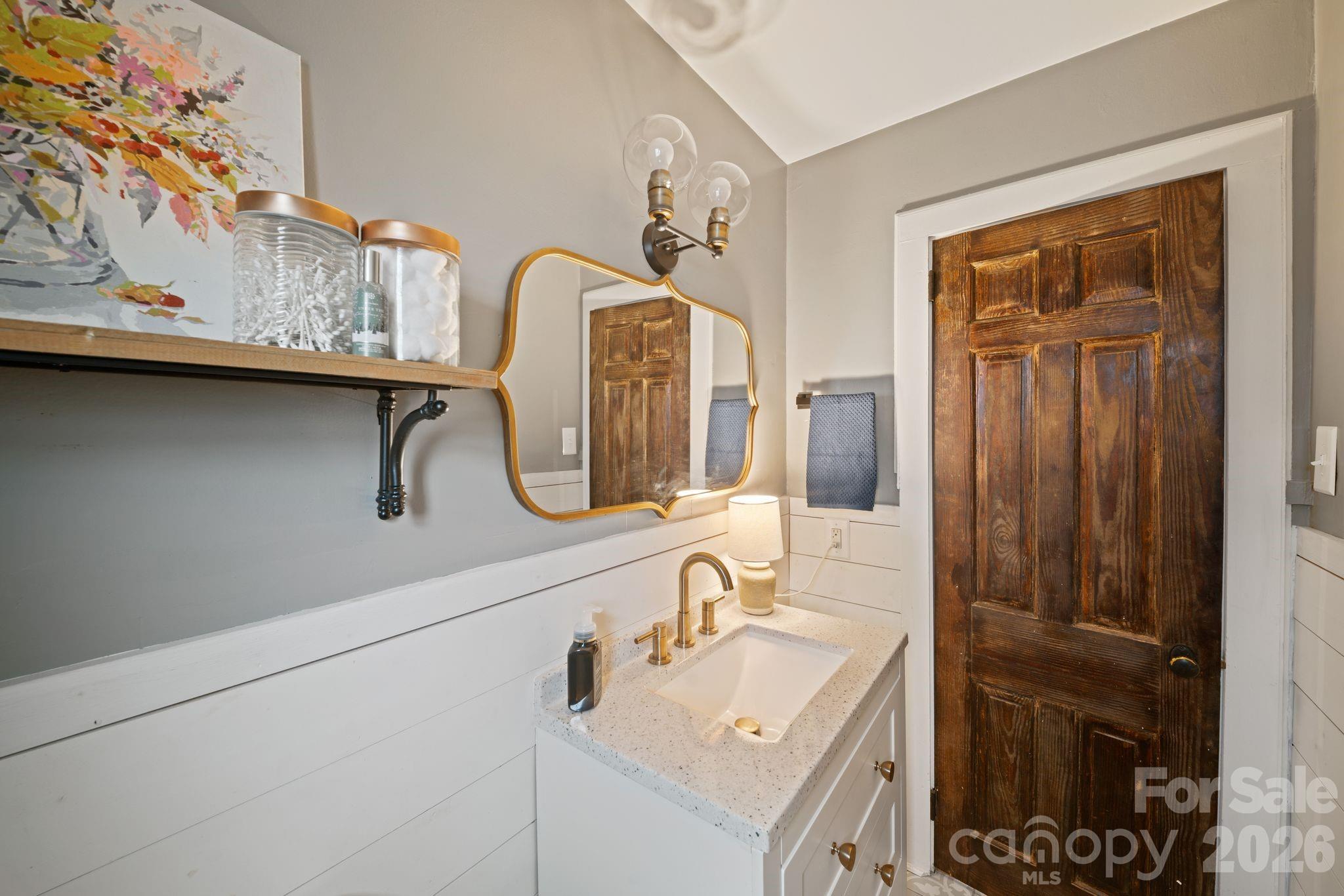 121 Johnson Street Canton, NC 28716 - Photo 21 of 32 a bathroom with a sink and a mirror