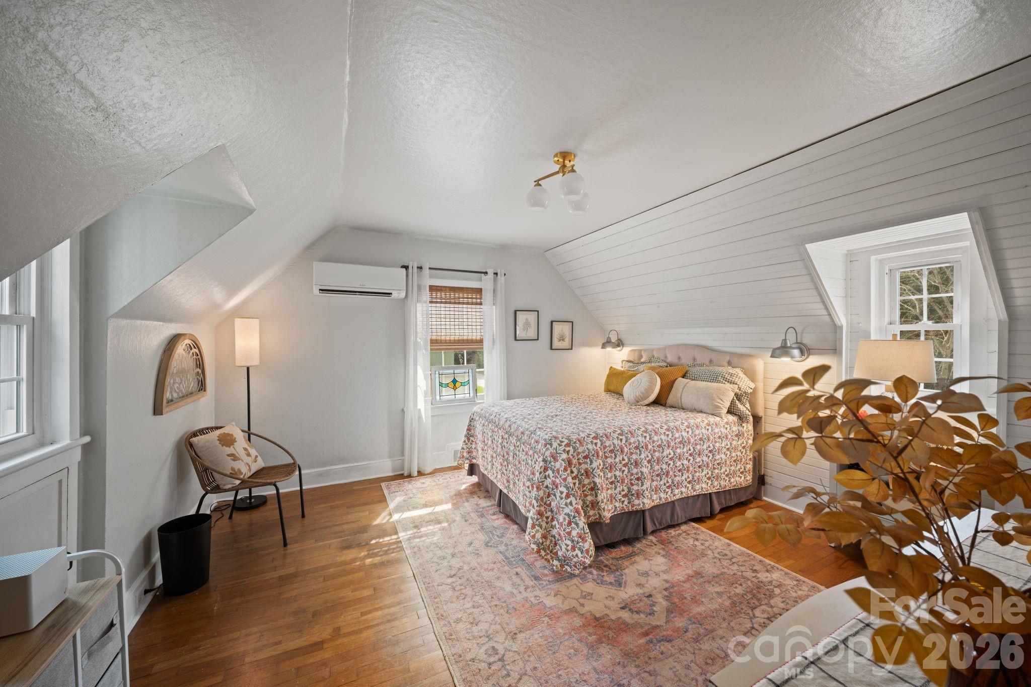 121 Johnson Street Canton, NC 28716 - Photo 24 of 32 a bedroom with a bed and wooden floor