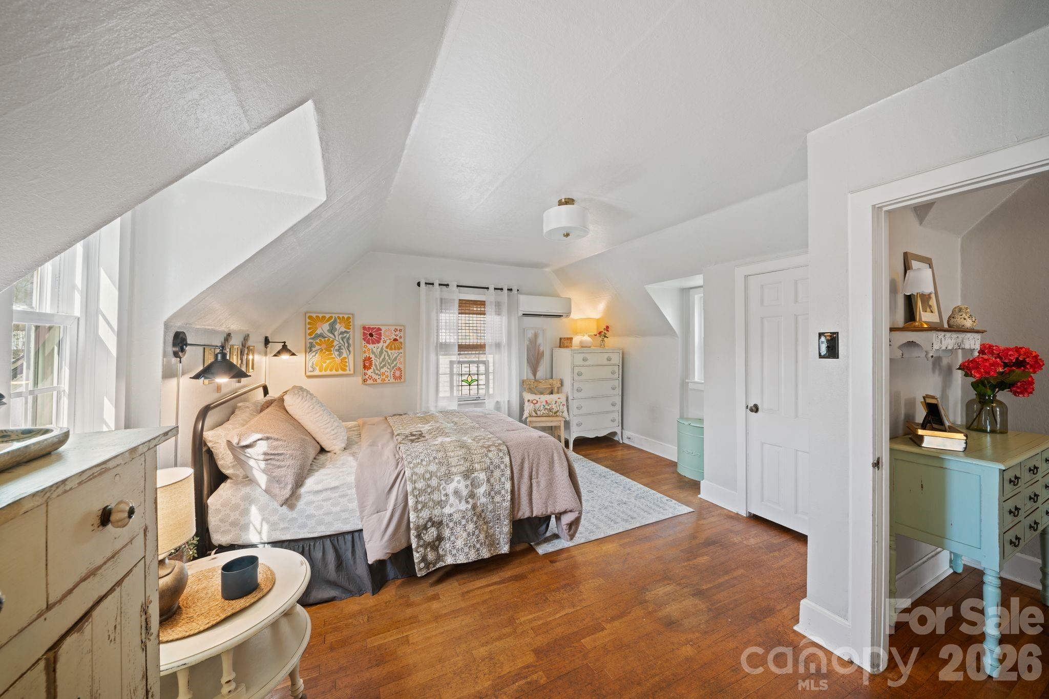 121 Johnson Street Canton, NC 28716 - Photo 27 of 32 a bedroom with furniture and a chandelier