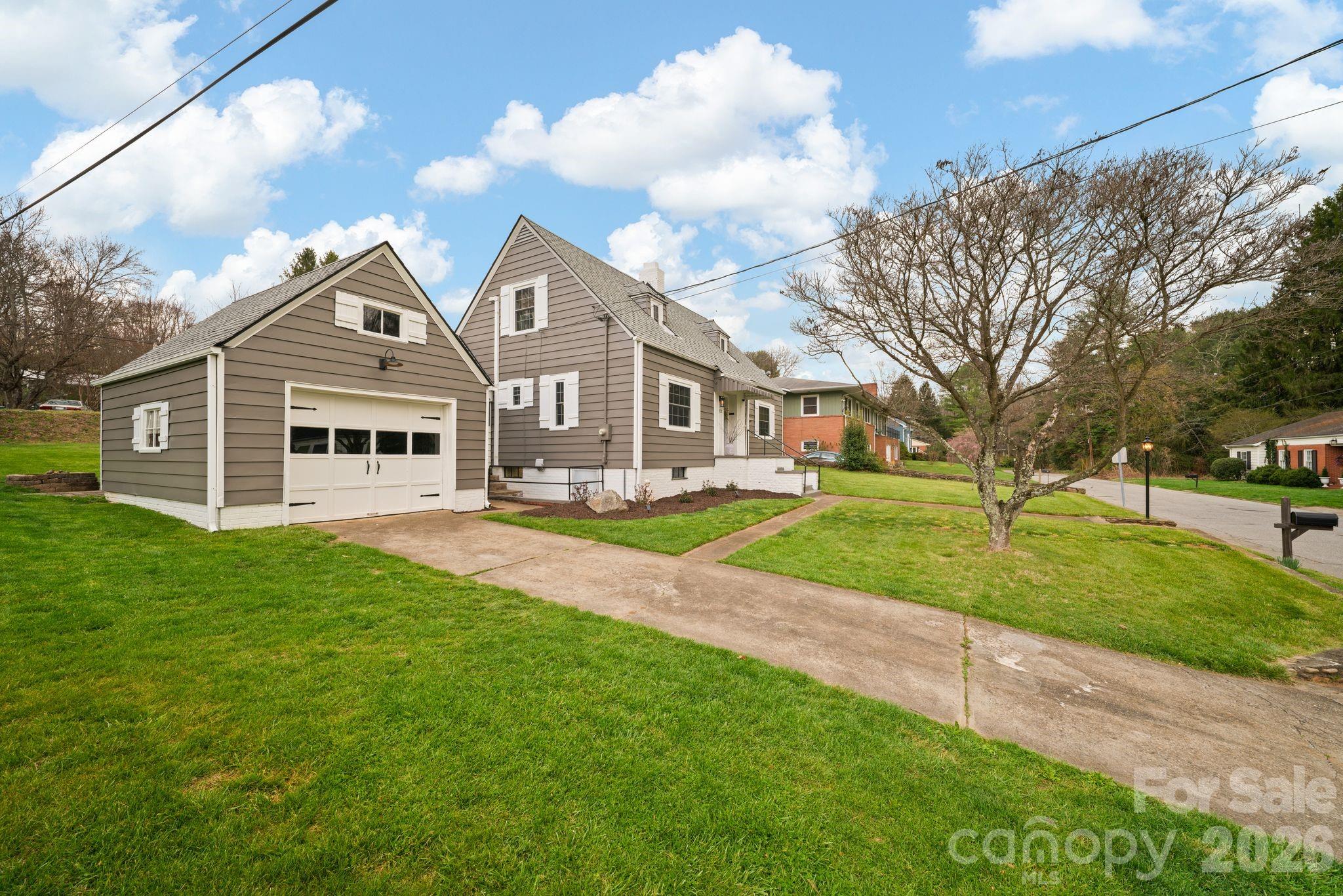 121 Johnson Street Canton, NC 28716 - Photo 4 of 32 a view of a big house with a big yard and large trees
