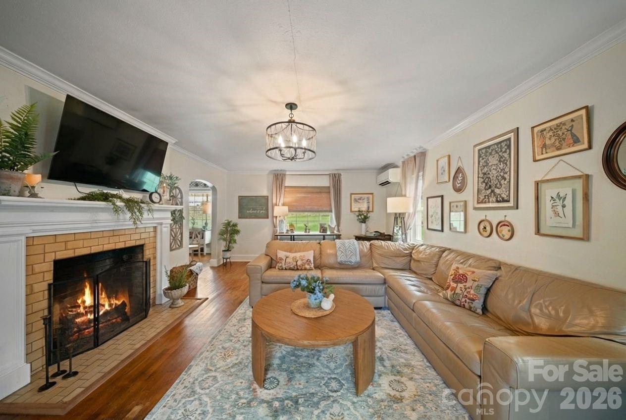 121 Johnson Street Canton, NC 28716 - Photo 8 of 32 a living room with furniture a flat screen tv and a fireplace