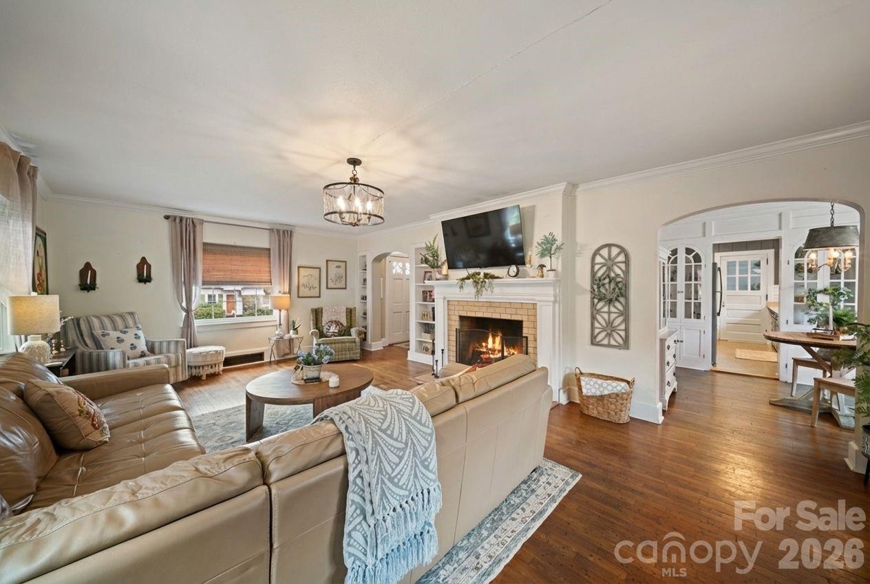 121 Johnson Street Canton, NC 28716 - Photo 9 of 32 a living room with furniture a fireplace and a flat screen tv