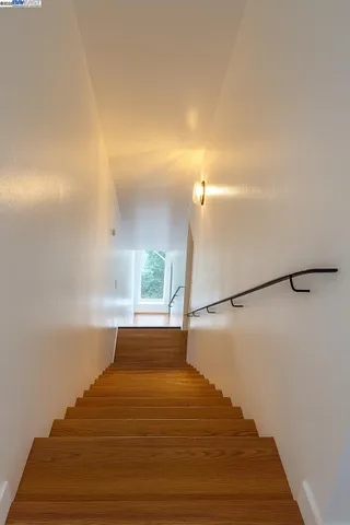 a view of a livingroom with furniture wooden floor and windows