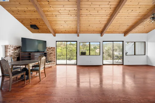 a dining room with furniture window and wooden floor
