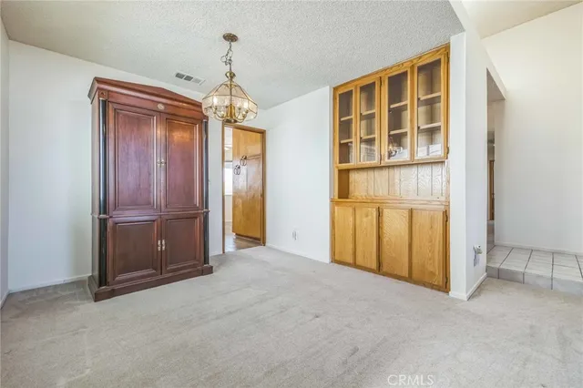 an empty room with closet and windows