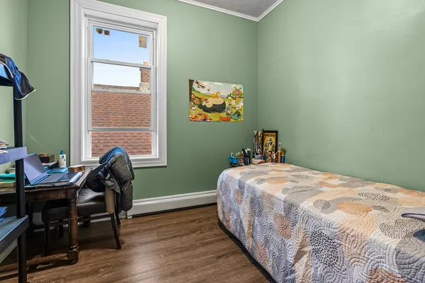 a bedroom with a bed and a window