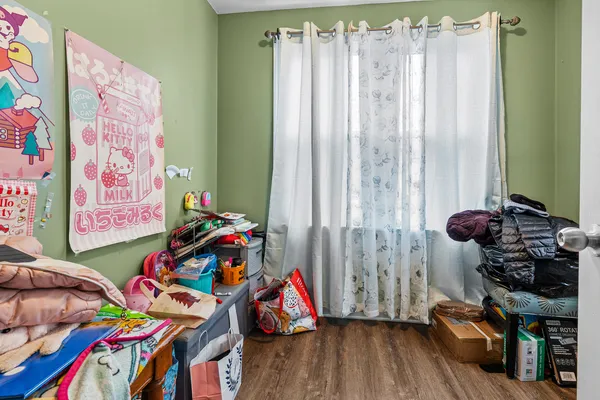 a view of kids room with toys and a book shelf