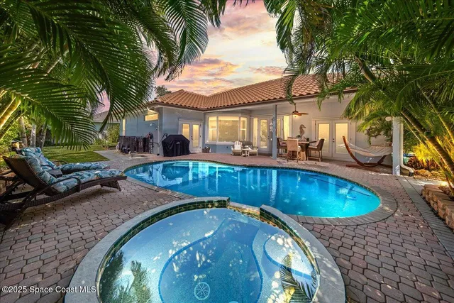 a swimming pool with outdoor seating and yard