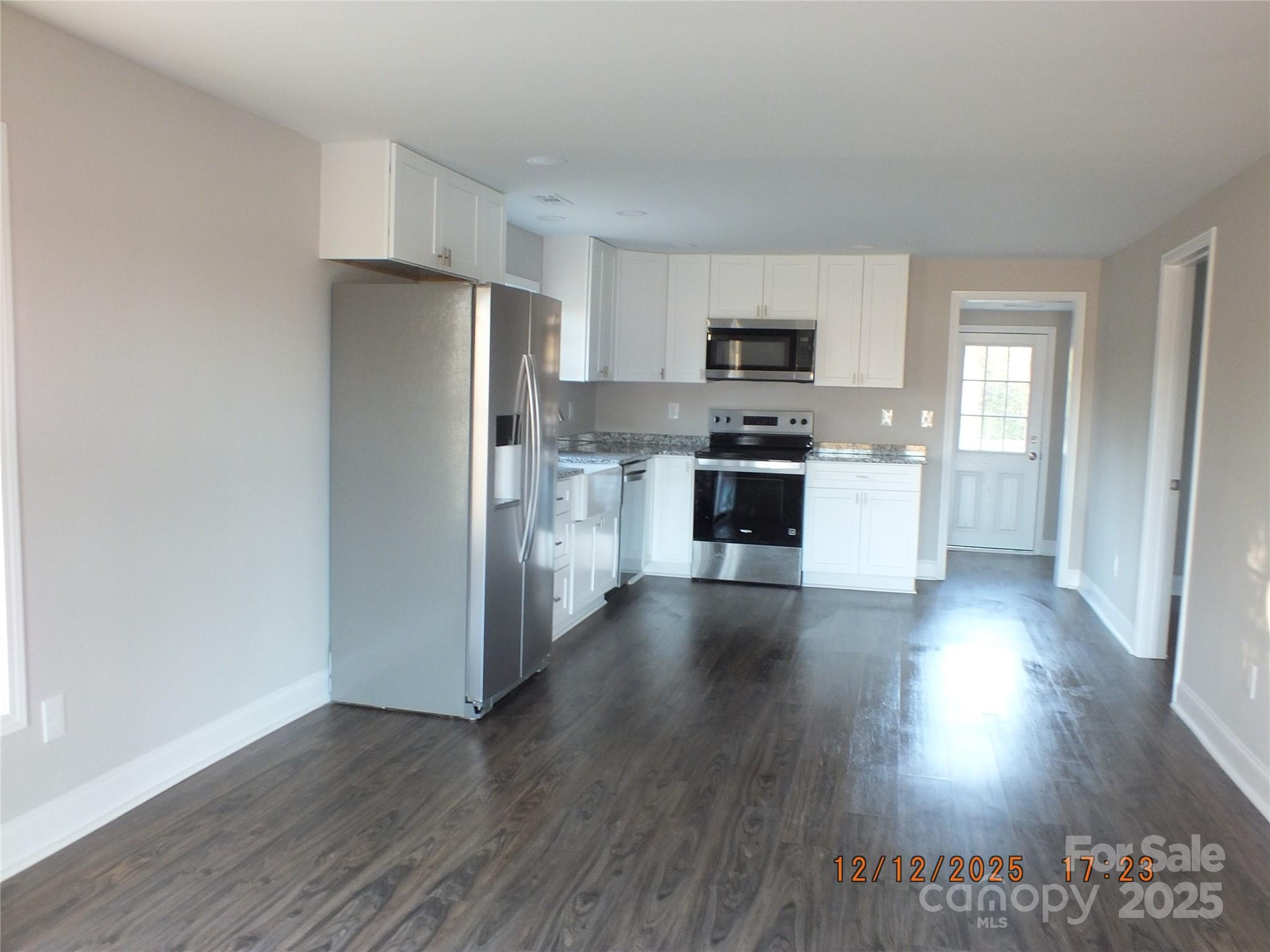 1740 Rocky River Road Lancaster, SC 29720 - Photo 11 of 31 a kitchen with stainless steel appliances a refrigerator and wooden floor