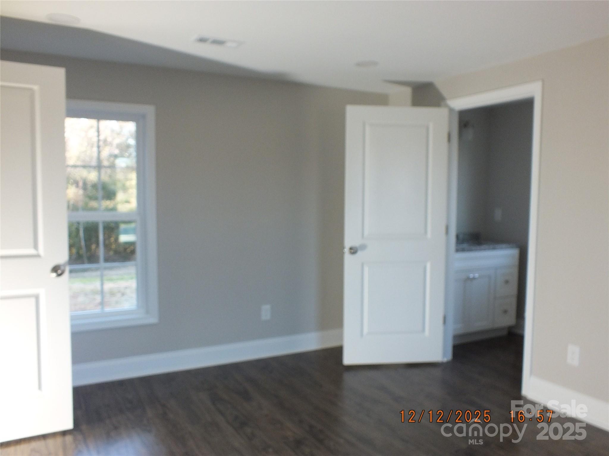 1740 Rocky River Road Lancaster, SC 29720 - Photo 13 of 31 an empty room with wooden floor and windows