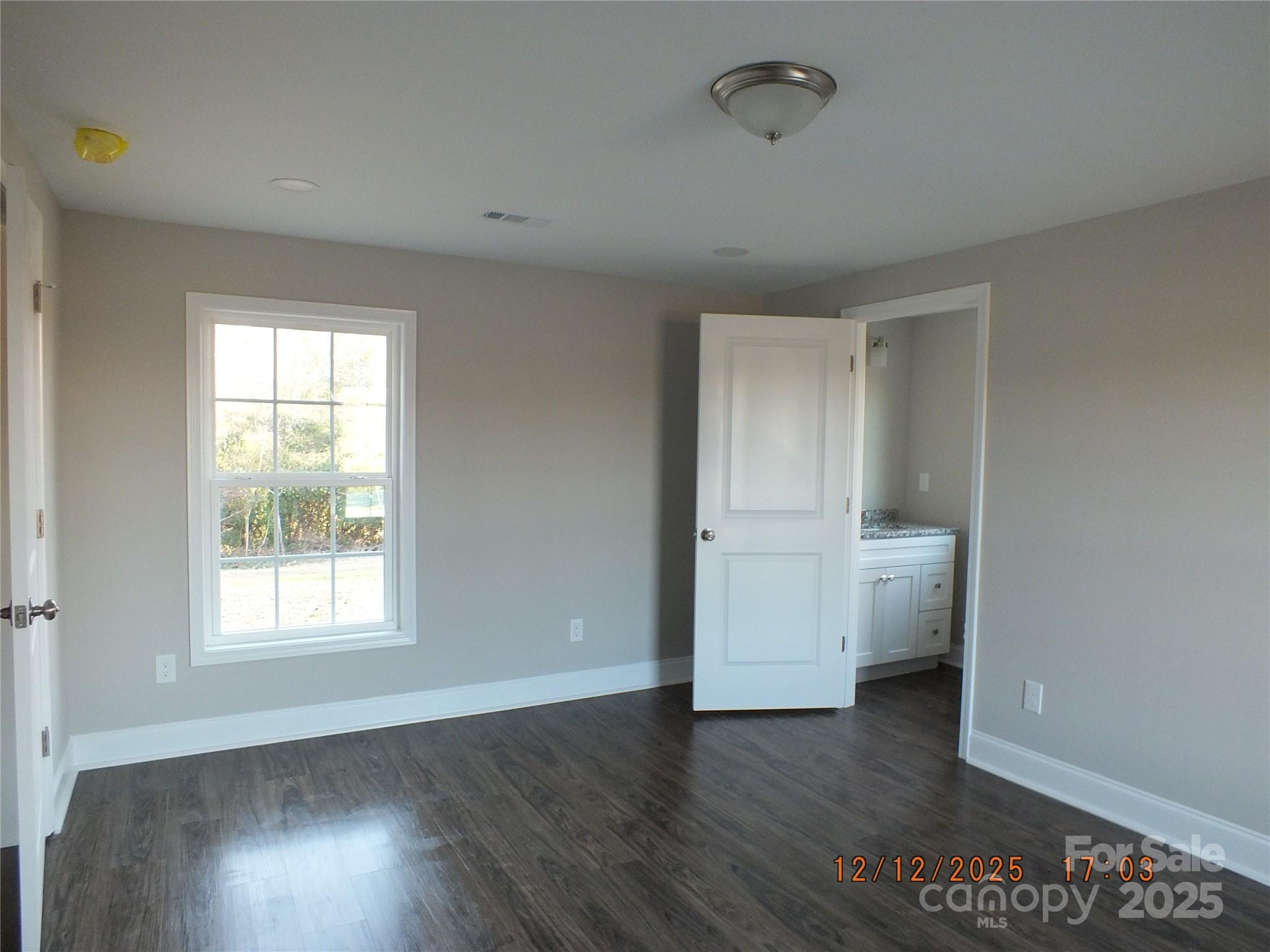 1740 Rocky River Road Lancaster, SC 29720 - Photo 15 of 31 a view of an empty room with wooden floor and a window