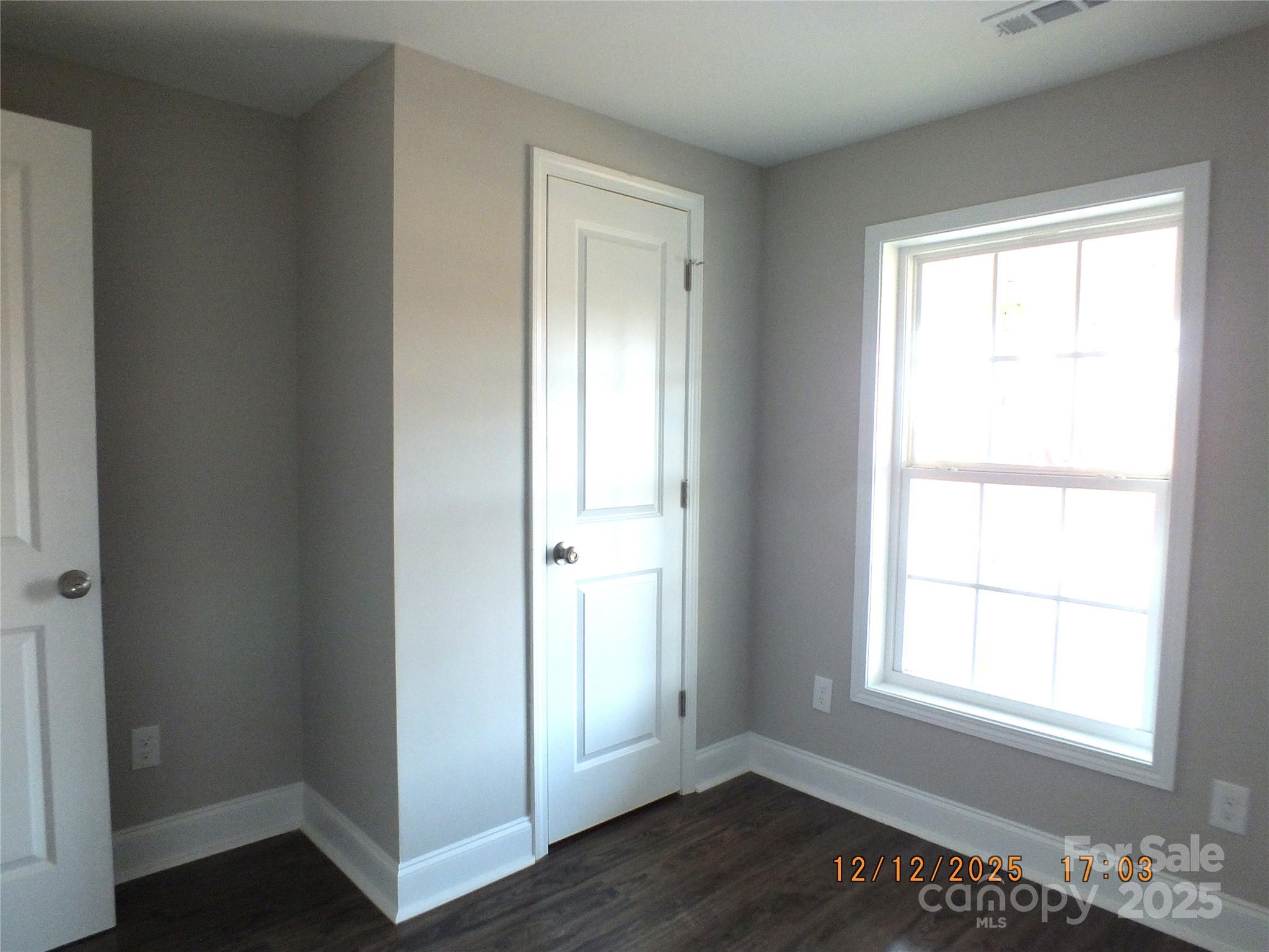 1740 Rocky River Road Lancaster, SC 29720 - Photo 18 of 31 a view of an empty room with wooden floor and a window