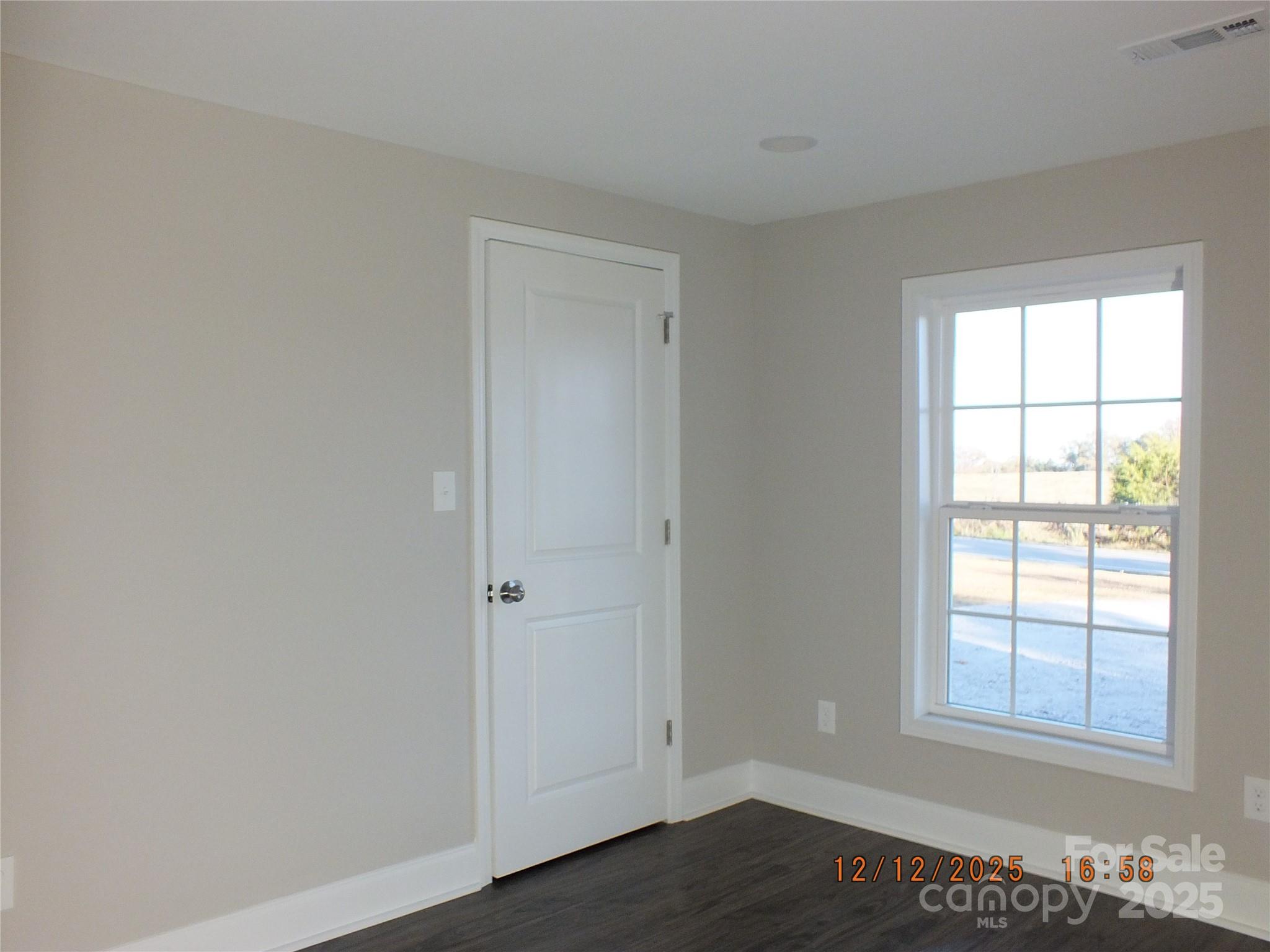 1740 Rocky River Road Lancaster, SC 29720 - Photo 23 of 31 an empty room with wooden floor and windows